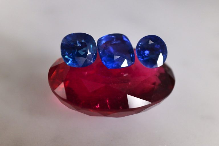 Three unheated blue sapphires perched on top a 78ct rubellite.